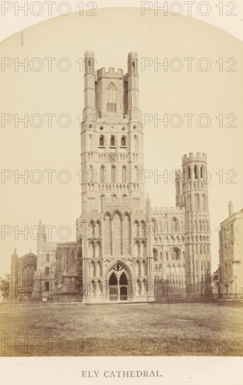 Ely Cathedral, photograph, page, Ely, c. 1858 - in or before 1869, photographer, Cambridgeshire, paper, albumen print, height 183 mm x width 127 mm, Photo on frontispiece., church (exterior), facade (of house or building), A large stone cathedral with a central tower flanked by a round tower and lower aisles stands on a grassy foreground; the central facade shows tall arched windows and decorative stonework with a recessed entrance featuring pointed arches and tracery, the main tower rising with multiple levels of narrow windows and a circular opening, the round tower to the side displaying vertical shafts and battlemented top, adjoining lower sections and buttresses extend to the left and right, and a paved area and fence run along the base of the building.