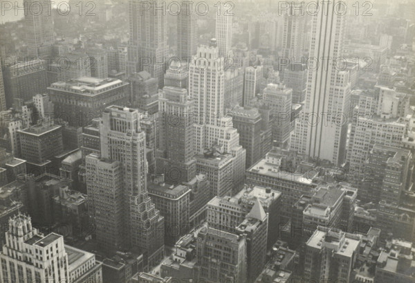 New York from RCA building, New York seen from the RCA Building (now GE Building), part of the Rockefeller Center, United States, photograph, title: 'NEW YORK FROM, RCA BUILDING', photographer: attributed to Wouter Cool, United States of America, 1936, North America, Attributed to, pasteboard, paper, gelatin silver print, height 157 mm x width 225 mm, height 315 mm x width 286 mm, city-view, and landscape with man-made constructions, skyscraper, Aerial view of a dense urban skyline with numerous tall rectangular buildings closely packed together, many with flat rooftops, visible mechanical structures, and varied architectural details such as setbacks, cornices, and decorative tops, rendered in a monochrome tone.