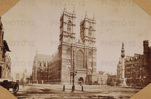 London. Westminster Abbey, photograph, 1850 - 1900, photographer, paper, albumen print, height 130 mm x width 180 mm, height 300 mm x width 250 mm, London, Westminster Abbey, A sepia-toned photograph of a large Gothic cathedral with two tall, ornate towers flanking a central arched entrance, detailed stone tracery and large arched windows, and decorative sculptural elements on the façade; a paved open area in front with a decorative lamppost and short posts with chains; to the right a tall column topped with a statue situated before a row of stone buildings with gabled roofs and a round turret; to the left additional stone buildings and architectural details and a partial view of a carriage wheel in a corner; the sky above is pale and the image has a worn, aged appearance.