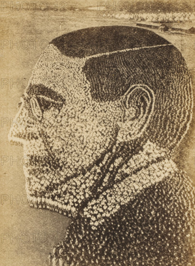 21, 000 American soldiers forming the portrait of President Woodrow Wilson, picture postcard, inscription: 'COPYRIGHT, MOLE AND THOMAS, One of the Most Difficult to Pose of the Many, 'Living' Pictures in Which Our Soldiers have Ap-, peared: This Likeness of the President Was Made Up, of 21, 000 Men, at Camp Sherman, Chillicothe, Ohio', photographer: Arthur S. Mole, Ohio, photographer: John Thomas, 1918, North America, paper, pasteboard, autotype, gelatin silver print, developing gelatin silver print after autotype, height 0 mm x width 0 mm, Person, Thomas Woodrow Wilson, A high-contrast, halftone-style side profile of a man's head and upper neck rendered in dark and light dots and lines on a beige background, showing a closely shaved top, short cropped hair on the sides, a prominent ear, a defined eyebrow, an eye with a heavy dark area around it, a nose and mustache, textured stubble on the lower face, and a patterned beard and neck area composed of clustered dots and strokes.