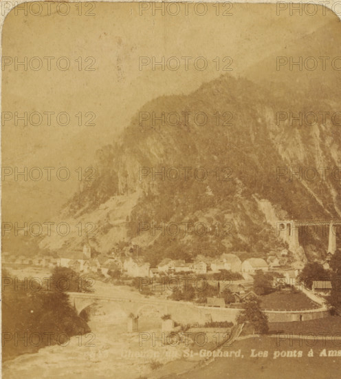 View of Amsteg with the Gotthard Massif, Switzerland, Chemin du St. Gothard : Les ponts à Amsteg, Views and landscapes in Europe, Africa and Asia, Geographical Sculpture Gallery, collected by MJ Broekhuijsen, Head of a school in Amsterdam, stereograph, Numbered 843. bottom left of photo, annotation: 'Alpine Switzerland', annotation: 'The village of AMSTEG lies at the entrance to the Madeiran Valley, 15 km north of Göschenen on the road across and the railway line through the St. Gothard., The railway line (in the background) shows a series of tunnels and viaducts here. Two viaducts are visible in the picture. The entrance to the tunnel is through, the trees hidden from view.', Uri, publisher: Merkelbach & Co., Amsterdam, compiler (person in literature): Martien Johan Broekhuijsen, c. 1905, photographer, compiler (person in literature), pasteboard, paper, albumen print, height 89 mm x width 178 mm, Part of a group of 52 stereophotos used in primary education as a supplement to school ch...