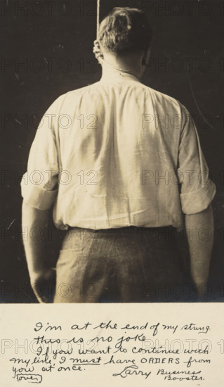 Advertisement for Kahn Bros, Louisville, picture postcard, inscription, United States of America, c. 1930 - c. 1950, photographer, North America, paper, gelatin silver print, developing gelatin silver print, height 138 mm x width 89 mm, Person, Kahn Bros, Kentucky, A sepia-toned photograph showing the back of a man from head to hips, wearing a light-colored long-sleeved shirt with sleeves rolled to the elbows and darker trousers; the man's hair is short and a rope hangs down behind his neck; the background is dark and plain, and the lower margin of the image shows a lighter area with handwritten script that is visible but not transcribed.