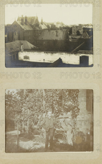 View of a walled prison complex with church in Oslebshausen, photograph, postcard, Part of Photo album of Carl Heinrich Fliegenschmidt, prison director in Oslebshausen., Oslebshausen, 1890 - 1910, photographer, Bremen (city), paper, gelatin silver print, developed gelatin silver print, height 78 mm x width 110 mm, fence, wall, paling, church (exterior), prison, jail, A faded photograph showing an elevated view of a cluster of older brick buildings with steeply pitched roofs and tall chimneys, a high pale wall with a gated opening in the foreground, a darker roofed structure partially obscured by trees behind the wall, and additional rooftops and tree-lined areas receding into the distance.