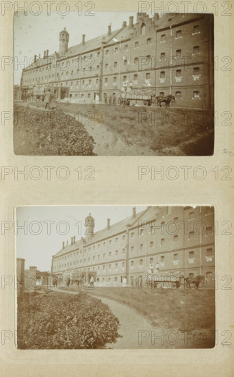 Exterior of Oslebshausen prison with workers by carts, photograph, Part of Photo album of Carl Heinrich Fliegenschmidt, prison director at Oslebshausen., Oslebshausen, c. 1890 - c. 1910, photographer, Bremen (city), pasteboard, paper, daylight collodion silver print, height 78 mm x width 110 mm, working class, laborers, prison, jail, animal traction, animal-drawn vehicle (carriage etc.), A sepia-toned photograph shows a long brick building with many small barred windows and a pitched roof with chimneys and a distinctive round tower rising above the roofline; in front of the building a dirt path curves beside a low hedge and an open grassy area; a horse-drawn wagon loaded with long bundled items stands near the building with a group of people nearby, some standing on the ground and some on the wagon; additional figures and a cart are visible further along the frontage near an arched entrance, and a small piled heap of material lies against the wall.