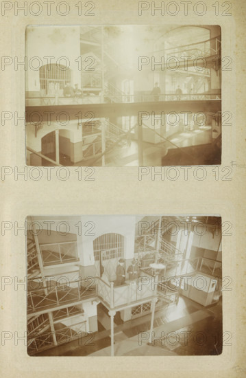 Interior of Oslebshausen prison with prison guards on a walkway, photograph, Part of Photo album of Carl Heinrich Fliegenschmidt, prison director at Oslebshausen., Oslebshausen, c. 1890 - c. 1910, photographer, Bremen (city), pasteboard, paper, daylight collodion silver print, height 78 mm x width 110 mm, prison, jail, prison personnel: jailers, warders, guards, A vertical photograph of two sepia-toned images mounted on textured paper showing an interior with multiple levels of metal walkways and staircases, arched doorways with barred openings, and column supports; the upper image is hazy and depicts railings, landings, and silhouettes of figures on a walkway, while the lower image is clearer and shows a central elevated platform with railings supported by slender columns, metal lattice staircases, window light casting shadows on a patterned floor, and a few figures standing on the platform and nearby walkways.