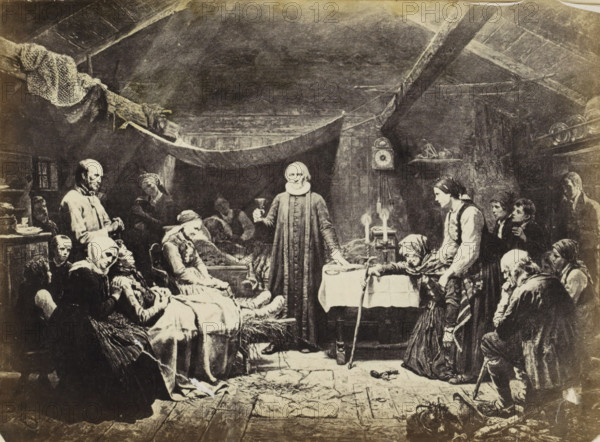 Photo reproduction of (presumably) a print after a painting by Adolph Tidemand, 'Communion of the sick' Tiedeman, photograph, reproduction, Part of an English family album with photos of people, travels, cricket and artworks., after print by anonymous, after painting by Adolph Tidemand, c. 1860 - c. 1870, photographer, after print by, paper, albumen print, height 145 mm x width 200 mm, functionaries and dignitaries (with NAME), Protestant churches, farm (building), A dim interior scene showing a group of people gathered in a low, beamed room with a sloping ceiling and a hanging cloth across the space. In the center a man in a long dark robe and a high collar stands behind a small table, holding a cup and resting a hand on the table where two lit candles sit. To his left, several seated and reclining figures occupy a bed and chairs, some with head coverings and shawls, one leaning forward with hands clasped. To his right, a young woman in a light blouse and dark vest leans toward the ta...