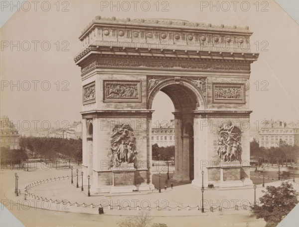 View of the Arc de Triomphe, album page, photograph, This photo is part of an album., retailer's mark: 'E. Hautecoeur, Estampes Photographies, 35 Avenue de l'Opéra, 35, Paris', inscription: '456B Arc de Triomphe. Ed. H.edit. Paris', photographer: Edouard Hautecoer (possibly), Paris, 1890 - 1898, paper, albumen print, height 258 mm x width 355 mm, triumphal arch, Arc de Triomphe, A large stone triumphal arch dominates the image, showing a central arched passage and flanking massive piers with high relief sculptures attached to their faces; decorative friezes and carved circular medallions run along the upper entablature, and rectangular relief panels sit above the arch on each pier. The arch opening reveals a coffered underside and a distant view through to buildings and trees beyond. A paved plaza surrounds the monument, edged by a low balustrade with chained posts and street lamps, and a few small groups of people and a solitary figure are visible near the base of the arch. Rows of tr...