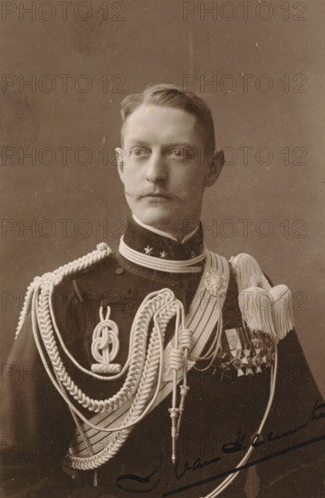 Toto van Heemstra, Portrait of Toto van Heemstra, photograph, cabinet photograph, signature: 'Toto van Heemstra', signature: 'Ebner, The Hague, Amsterdam', photographer: Ferdinand Robert Ebner, Amsterdam, 1880 - 1920, pasteboard, paper, matte daylight collodion silver print, height 145 mm x width 93 mm, height 165 mm x width 103 mm, Person, historical persons, Netherlands, A sepia portrait of a man shown from the chest up wearing a dark military uniform adorned with elaborate braided cords and aiguillettes draped across his chest, a high collar with decorative stars, a sash, a row of medals on his left side, and large tasseled epaulettes; he has neatly combed hair, a trimmed mustache, a neutral expression, and is gazing slightly to his left against a plain backdrop.