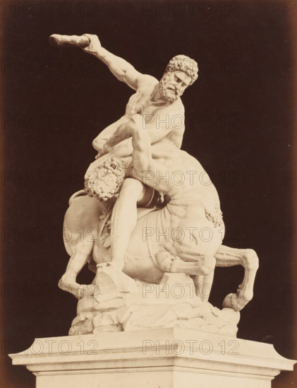 Il Centauro di Gian Bologna, Sculpture of Hercules and the centaur Nessus after Giambologna, Firenze, photograph, number: '3084', address: 'GIACOMO BROGI, FOTOGRAFO-EDITORE, FIRENZE, LUNG ARNO DELLE GRAZIE 15', photographer: Giacomo Brogi, Florence, publisher: Edizioni Brogi, after sculpture by Giambologna, 1864 - 1881, Giambologna, after sculpture by, Tuscany, pasteboard, paper, albumen print, height 470 mm x width 350 mm, piece of sculpture, reproduction of a piece of sculpture, Loggia dei Lanzi, A pale stone sculpture of two muscular male figures and a horse is shown against a dark background, with one man seated on the horse and leaning forward while gripping the other man's arm, the seated man holding a cylindrical club aloft with a tense arm and a bearded face turned downward, the other man bent backward across the horse with a contorted face and curly hair, the horse's head lowered and legs visible beneath the figures, all positioned on a carved rocky base atop a rectangular pli...