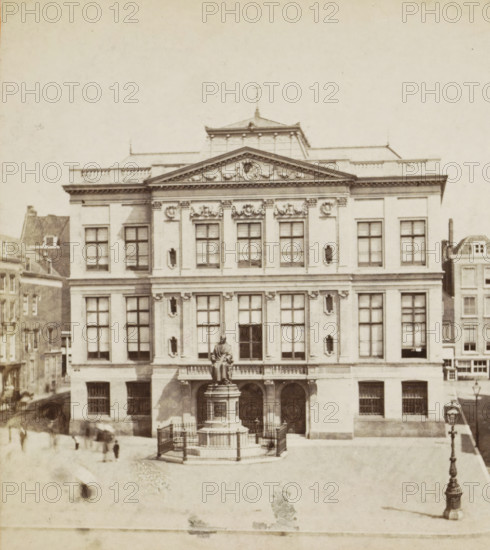 View of the Van Hogendorpsplein with the Schielandshuis and the statue of Gijsbert Karel Count van Hogendorp in Rotterdam, Museum Boijmans, Rotterdam, stereograph, inscription: 'JHGR No. 49', retailer's mark: 'W. DE BESTE J.CZ., GOES', after sculpture by Jozef Geefs, 1867 - 1890, Jozef Geefs, photographer, after sculpture by, pasteboard, paper, albumen print, height 86 mm x width 172 mm, Person, Gijsbert Karel Count van Hogendorp, villa, Schielandshuis, A large classical stone building with a triangular pediment and decorative sculptural details above a row of tall rectangular windows, a central balcony with a seated statue on a pedestal in front, a low iron fence around the statue, arched entrances beneath the balcony, symmetrical window arrangements on the façade, adjacent narrower buildings visible at the sides, a cobbled open square in front with a few indistinct blurred figures, and an ornate street lamp on the right side.