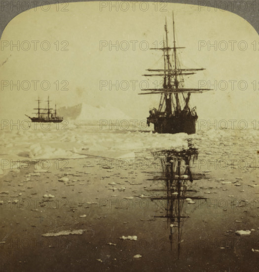 Whalers 'Diana' and 'Nova Zembla' sailing near Dexterity Harbour, Baffin Island, Whalers 'Diana' and 'Nova Zembla' cruising in the Arctics - Dexterity Harbor and Baffin Land, stereograph, inscription: 'K 5', inscription: 'Canada', number: '40, ', copyright notice: 'Copyright 1902 by Underwood & Underwood.', inscription: 'The Whalers, och Baffinslandet.', inscription: 'Works and Studios, Arlington, NJ Westwood, NJ Washington, DC', Dexterity Island, publisher: Underwood and Underwood, New York (city) (possibly), 1902, photographer, North America, pasteboard, paper, albumen print, height 88 mm x width 178 mm, whale fishery, whaling, ships (in general) - CC - more than one ship, drift ice, Two sailing ships are visible on a pale, textured sea surface, one larger and closer at right with tall masts and rigging and a dark hull casting a vertical reflection in the water, and a smaller ship farther left with multiple masts seen against a lighter background; the foreground shows scattered ice f...