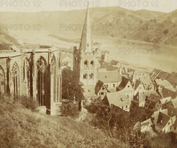 Panorama de Bacharach, View of the Werner Chapel and St. Peter's Church in Bacharach, Germany, Bords du Rhin, stereograph, number: 'No 88', inscription: '1875 No 24 Za 25 Sept.', Bacharach, 1857 - 1863, photographer, Rhineland-Palatinate, pasteboard, paper, albumen print, height 86 mm x width 174 mm, city-view, and landscape with man-made constructions, parts of church exterior and annexes: tower, ruin of church, monastery, Werner Chapel, St. Peter's Church (Bacharach), A sepia-toned aerial view showing the upper portion of a Gothic church with tall pointed arched windows and ornate tracery on the left, a square clock tower with a tall spire rising near the center, steeply pitched roofs and half-timbered houses clustered below and to the right, a grassy hillside in the foreground, scattered trees among the buildings, and distant rolling hills and a wide river or body of water in the background.