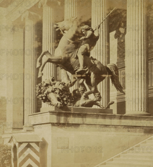 Statue of the Lion Killer after Albert Wolff for the Altes Museum in Berlin, Lowentödter von Wolff for the Königlichen Museum, Berlin and Environment, stereograph, number: '40.', photographer: Sophus Williams, Berlin, after sculpture by Albert Wolff, 1876, Albert Wolff, after sculpture by, pasteboard, paper, albumen print, albumendruk, height 86 mm x width 176 mm, monument, statue, front steps, Altes Museum, A sepia-toned photograph of a stone equestrian statue showing a rearing horse and a partially draped rider holding a long staff, positioned on a raised plinth in front of tall fluted columns; below the horse a sculpted lion lies on its back with a mane of carved curls, and decorative foliage forms part of the base; to the left a small guardhouse with diagonal stripes stands near the corner of the plinth, and a broad flight of stone steps ascends to the right.