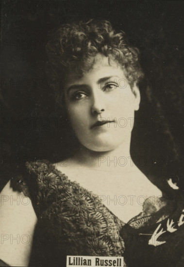 Portrait of Lillian Russell, advertisement for Orion W. Lemer, Lillian Russell, photograph, United States of America, 1895 - 1910, photographer, North America, paper, baryta paper, gelatin silver print, developing gelatin silver print, height 60 mm x width 42 mm, Such photographs were known as 'blackies'. They were obtained when purchasing certain brands of tea, cocoa, cigarettes, biscuits, etc. for collecting. There were collector albums in circulation specifically for the 'blackies'., Person, historical persons, adult woman, advertisement, A sepia-toned portrait of a young woman shown from the shoulders up with curly hair styled close to her head, large dark eyes looking slightly upward, a straight nose, and closed lips. She wears a textured garment with intricate floral-like patterns and a darker background surrounds her. The lighting creates soft shadows on one side of her face and neck.