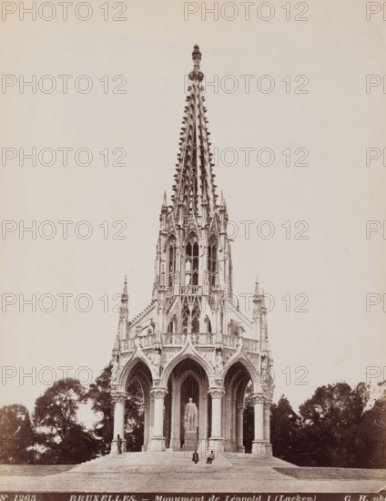Monument to King Leopold I of Belgium in Brussels, Belgium, Monument de Léopold I (Laeken), Bruxelles, photograph, number: 'No 1265', photographer: Gustave Hermans, Laeken, 1884 - 1914, Brussels, paper, albumen print, height 281 mm x width 218 mm, Person, Leopold I (King of the Belgians), monument, statue, Monument for the Dynasty, A tall ornate Gothic spire rises from an intricately carved stone pavilion with pointed arches and clustered columns, the upper section showing delicate tracery, pinnacles, and sculptural details, while the lower section features arched openings supported by tall round columns and a standing statue on a pedestal visible within the central arch, with steps leading up to the structure and trees flanking the sides.