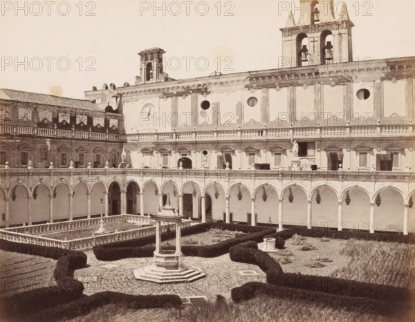 Cloitre a la Chartreuse S.Martin, Courtyard of the Charterhouse of Saint Martin in Naples, Italy, Naples, photograph, number: 'No 4070', number: '12', number: '3.', photographer: attributed to Giorgio Sommer, 1857 - 1914, Attributed to, pasteboard, paper, albumen print, height 307 mm x width 404 mm, cloisters, monastery, Carthusian Monastery San Martino, A sunlit stone courtyard with an ornate central well surrounded by a patterned paved area and low clipped hedges, framed by a two-story building with a long colonnaded arcade of rounded arches on the ground level and a balustraded gallery above, decorative rectangular wall panels and circular openings on the upper façade, sculpted statues and reliefs set into niches, a clock face on one wall, and bell towers rising above the roofline.