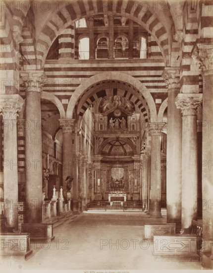 Interno del Duomo lato diritto, Interior of the Cathedral of Pisa, Italy, Pisa, photograph, number: '3451', 1851 - 1900, photographer, Tuscany, pasteboard, paper, albumen print, height 384 mm x width 308 mm, parts of church interior, Duomo (Pisa), A sepia-toned interior view of a large vaulted space with alternating light and dark horizontal stripes on arches and walls, tall fluted columns with ornate carved capitals lining the central aisle, and a raised ornate altar area at the far end featuring sculpted figures and decorative panels beneath an arched canopy; side aisles with balustrades and sculptural elements flank the central walkway, and the ceiling shows layered arches and openings above the altar.