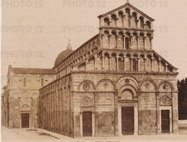 Exterior of the Cathedral of Pisa, Italy, S. Francesco Duomo Vecchio, Pisa, photograph, number: '1045.', 1851 - 1900, photographer, Tuscany, pasteboard, paper, albumen print, height 310 mm x width 385 mm, church (exterior), Cathedral of Pisa, A sepia-toned photograph of a large stone church facade showing multiple levels of arched openings and columns, a dome with a spherical finial topped by a cross visible behind one side, decorative circular and geometric stone carvings above entrances, tall rectangular wooden doors set into arched doorways, alternating horizontal bands of lighter and darker stone on the exterior walls, a row of small columned arches running along the nave, a prominent gabled section with stacked arcades and paired columns, and a narrow alley running alongside the building leading to another entrance.