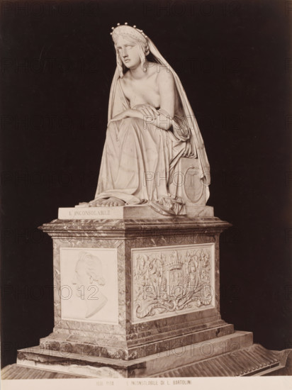 L'Inconsolabile di L. Bartolini, Statue of the Inconsolable after L. Bartolini, Pisa, photograph, number: '1031.', inscription: 'BFH Rives', photographer: BF Rives, after sculpture by Bartolini, 1851 - 1900, BF Rives, Bartolini, photographer, after sculpture by, Toscane, pasteboard, paper, albumen print, albumendruk, height 385 mm x width 310 mm, piece of sculpture, reproduction of a piece of sculpture, A carved marble sculpture of a seated draped female figure wearing a crown and a long veil, her head tilted and eyes closed, one arm resting across her lap and the other arm bent with a hand touching her forearm, her garments falling in detailed folds over a square pedestal that features a profile relief of a man's head on one side and an ornate heraldic panel with a shield and floral motifs on another, all set against a dark background.