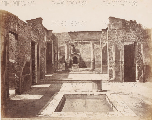 Remains of a house in Pompeii, Italy, Pompei maison Poete Tragique (Glanco) Mosaique Cave Canem fouilles 1824, photograph, number: '11', number: '25', photographer: attributed to Giorgio Sommer, Pompeii, 1857 - 1875, Attributed to, pasteboard, paper, albumen print, albumendruk, height 306 mm x width 405 mm, ruin of a building, architecture, excavation, archeology, A sunlit ruin courtyard with stone walls and columns, an empty rectangular basin set into the paved floor in the foreground, a short fluted cylindrical pedestal standing near the basin, weathered stone doorways and window openings lining both sides, textured masonry and plaster surfaces with visible cracks and patches, a shallow raised platform and mosaic-like floor area further back, and a small recessed niche framed by architectural detailing centered on the far wall.