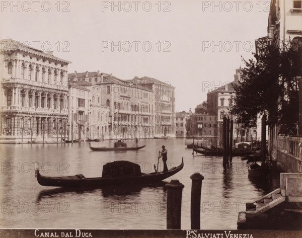 Canal dal Duca, Gondolas in the Grand Canal in Venice, photograph, inscription: 'Venetié', photographer: Paolo Salviati, Venice, 1860 - 1870, pasteboard, paper, albumen print, albumendruk, height 197 mm x width 249 mm, height 276 mm x width 363 mm, canal, gondola, Grand Canal, A wide canal scene with ornate multi-story buildings lining the far bank, featuring arched windows and decorative facades, boats and gondolas floating on the water, a gondolier standing and rowing near the center foreground, another gondola with a covered seating area closer to the front, mooring posts rising from the water along the right side, a tree partially obscuring the buildings on the right bank, stone steps and a small waterfront railing visible at the lower right edge, and gentle reflections of the boats and buildings on the canal surface.