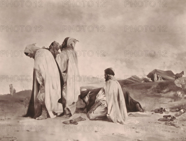 Arabes en prière, Reproduction of Arabes en prière by Eugène Fromentin-Dupeux, reproduction, page, photomechanical print, inscription: 'Galerie Contemporaine, Littéraire, Artistique, 126, boulevard de Magenta, Paris', cliché maker: Goupil & Cie., after design by Eugène Fromentin-Dupeux, c. 1872 - in or before 1877, photographer, paper, Woodburytype, height 168 mm x width 218 mm, painting, drawing and the graphic arts, ritual objects and ritual means, non-Christian religions, A group of robed figures occupies the foreground against a wide, clouded sky; three standing figures wear long draped garments with hoods and bowed heads, one of them holding a small bag, while two other figures kneel on the ground nearby with one facing slightly toward the viewer and the other bent forward. Scattered on the sandy ground are several pairs of simple footwear and a few small objects. In the middle ground a lone figure walks away toward distant low hills, and beyond them a small cluster of figures sta...