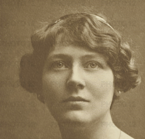 Portrait of an unknown woman, photograph, c. 1891 - c. 1896, photographer, paper, gelatin silver print, developed gelatin silver print, height 150 mm x width 156 mm, height 367 mm x width 274 mm, This photograph is not mentioned in the publication of the Troisième Exposition d'Art Photographique. It may have been added to the cover later., adult woman, historical persons not known by name - BB - woman, A sepia-toned close-up of the upper face and lower neck of a person with short wavy hair, visible eyes looking slightly upward, softly arched eyebrows, a straight nose, closed lips with a neutral expression, a rounded chin, a smooth neck, and a small earring visible at one ear, all against a plain background with a textured, aged appearance.