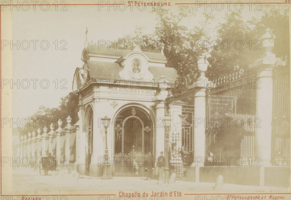 Chapel and entrance to the Spring Garden in Saint Petersburg, St. Pétersbourg. Chapelle du Jardin d'Eté., photograph, cabinet photograph, Part of Leporello album with recordings of St. Petersburg., inscription: '20.', photographer: Joseph Daziaro, St. Petersburg, c. 1880 - c. 1900, Joseph Daziaro, photographer, Saint-Petersburg, Leningradskaya, paper, pasteboard, albumen print, albumendruk, height 95 mm x width 145 mm, public gardens, park (city(-scape) with figures, staffage), church (exterior) - QQ - small church, chapel, gate, entrance, A pale sepia photograph shows an ornate gatehouse set into a long stone and wrought iron fence, the gatehouse featuring arched doorways, decorative roof tiles, sculpted reliefs, and a rounded central pediment with a carved medallion. Tall stone pillars topped with urn-shaped finials flank the entrance and continue along the fence, which has pointed iron spearheads and intricate scrollwork. Two street lamps on slender posts stand near the entrance, an...