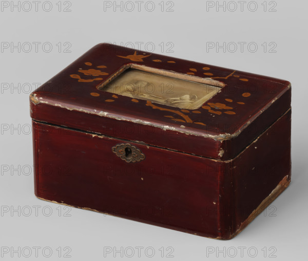 Red Japanese lacquer box with albumen print on the lid, photograph, lacquer box, Red Japanese lacquer box with albumen print on the lid used to store photos., unknown, lacquerer: anonymous, c. 1870 - c. 1900, photographer, paper, plant material, paint (coating), biological material, wood (plant material), enamel paint, albumen print, height 0 mm x width 0 mm, A rectangular lacquered box with rounded edges in a deep red color showing worn and chipped areas along the corners and edges, a recessed rectangular opening on the top containing a faded sepia-toned image, gold-colored floral and bird motifs painted on the top surface, a decorative metal keyhole plate on the front, and visible seams where the lid meets the body.