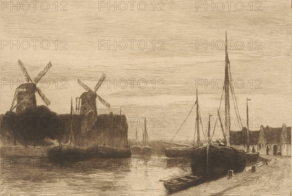 River view with moored boats and two windmills, Aan 't Spaarne (original title), print, printmaker: Philip Zilcken, after design by Johan Hendrik Weissenbruch, 1867 - 1890, Philip Zilcken, Johan Hendrik Weissenbruch, printmaker, after design by, paper, etching, drypoint, intaglio printmaking technique, height 179 mm x width 229 mm, windmill, river, Haarlem, Spaarne (river), A sepia-toned etching shows a waterfront scene with several moored boats in the foreground and middle distance, their hulls reflected in rippled water. Two large windmills with angled sails rise on the left behind a dark mass of trees and buildings. Upright masts and rigging of sailboats punctuate the skyline toward the right, including one very tall slender mast. Low buildings and docks line the water's edge, and a small rowboat rests near the shore in the lower right. The sky is filled with fine, horizontal etched lines.