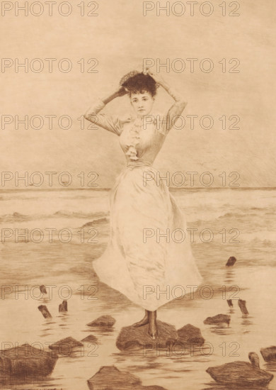 Mouettes, Young woman on a stone in the surf, print, printmaker: Léon Lowenberg (signed by artist), c. 1875 - in or before 1912, paper, etching, drypoint, intaglio printmaking technique, etching and drypoint with plate tone, height 366 mm x width 258 mm, A sepia-toned drawing of a woman standing on a rock at the water's edge, wearing a long flowing dress with a fitted bodice and ruffled front, holding a hat above her head with both hands; the scene shows gentle waves in the background, scattered rocks and wooden posts emerging from the shallow water, and a distant horizon line under a textured sky.