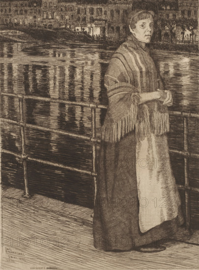 Woman by a railing by the water, Une épave, print, printmaker: François Maréchal, 1895, paper, etching, drypoint, intaglio printmaking technique, drypoint and plate tone, height 294 mm x width 218 mm, adult woman, canals, waters (in city), A sepia-toned etching shows a woman standing on a wooden platform beside a metal railing with horizontal bars, her hands clasped at waist height. She wears a long, dark skirt and a shawl with fringed edges draped over her shoulders, the shawl displaying broad, contrasting stripes. Her face is turned slightly toward the viewer with a neutral expression, short hair framing her forehead. Behind her, a body of water reflects vertical streaks of light and shadow, and the opposite bank features buildings with lit windows and street lamps that cast bright points of light. Trees line the distant shore, and the overall scene is rendered with fine, dense lines and crosshatching.
