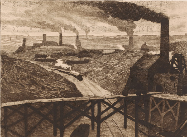 Industrial landscape with viaduct and a passing train, print, printmaker: Karl Meunier, after painting by Constantin Emile Meunier, 1892, paper, etching, intaglio printmaking technique, drypoint, plate tone and drypoint, height 206 mm x width 295 mm, The title of the painting from which the print was made is: 'Au pays noir'. This title refers to the name of the area 'Pays Noir', an industrial area around Charleroi., factory in landscape, railway, train, industries, Charleroi, A sepia-toned landscape rendered in dense etched lines shows a river valley with steep banks and a winding waterway flowing toward the foreground, crossed by a wooden trestle bridge with visible supports. Buildings with tall vertical chimneys stand on the ridges and along the valley, each chimney emitting billowing dark smoke that stretches across the sky. A small locomotive with a plume of steam is visible on the track running along the riverbank, and several rectangular roofed structures cluster near the chimney...