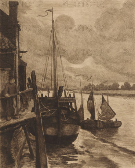 View of boats in the Scheldt near Rupelmonde, print, inscription: '1er Etat KM', printmaker: Karl Meunier, 1874 - 1894, paper, etching, drypoint, intaglio printmaking technique, drypoint and plate tone, height 325 mm x width 267 mm, sailing-ship, sailing-boat, landscapes with waters, waterscapes, seascapes (in the temperate zone), Scheldt, Rupelmonde, A sepia-toned scene of a riverside with several moored sailboats, their masts and furled sails rising against a cloudy sky, a larger boat in the foreground tied to a wooden dock with a coiled rope and anchor visible on its deck, a man standing on the dock near a building with a tiled roof and chimney holding a plank, wooden posts and beams forming the dock structure, distant low tree-lined shore across the water, and swirling textured clouds filling much of the upper area.