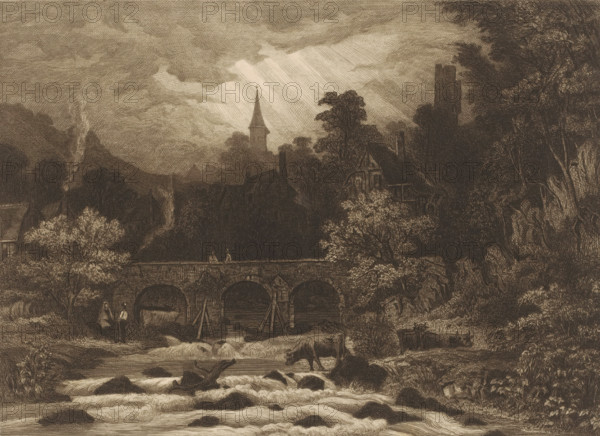Landscape with village in a mountain valley along a river with bridge, print, printmaker: Auguste Numans (signed by artist), 1833 - 1879, paper, etching, intaglio printmaking technique, roulette, height 197 mm x width 275 mm, prospect of village, silhouette of village, bridge in village across river, canal, cow, river (landscape with figures, staffage), A sepia-toned engraved landscape showing a stone arched bridge spanning a flowing river with rapids and rocks in the foreground, a cow standing on a rocky bank and other cattle in the water, two figures near the riverbank and one standing on the bridge, trees with dense foliage flanking the scene, timber-framed houses and chimneys partially obscured by trees behind the bridge, a church steeple and a square tower rising above the treeline, streaks of light breaking through heavily textured clouds, and smoke rising from a distant chimney.
