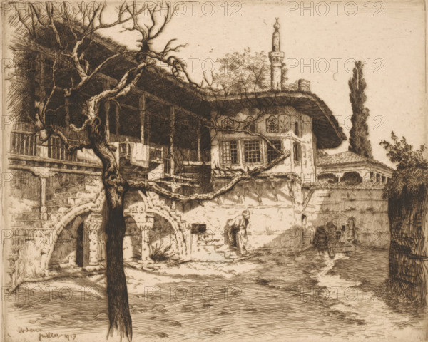 View of a courtyard in Edessa, Vodena July 1917, print, printmaker: Louis Godefroy (signed by artist), 1917-07, paper, etching, drypoint, intaglio printmaking technique, height 207 mm x width 254 mm, courtyard, Edessa, An etching of an old building with a covered balcony and ornate windows, a tall minaret rising behind the roof, twisted bare tree branches in the foreground, a stone archway with carved columns, a person wearing draped clothing and a head covering walking near the wall, tiled roofs, dense vertical foliage at the right edge, and textured ground and walls rendered in fine crosshatching.