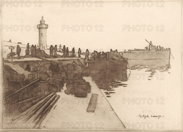 View of a quay with sloops in Cannes, print, printmaker: Eugène Bejot, Cannes, 1893, Provence-Alpes-Côte d'Azur, paper, etching, intaglio printmaking technique, roulette, height 199 mm x width 277 mm, ships (in general) - CC - more than one ship, quay, lighthouse, lightship, A sepia-toned sketch showing a harbor scene with a long pier stretching toward the right where a large boat sits at the waterline, its hull reflected in rippling water. Along the left edge a cylindrical lighthouse rises above the pier with a small gallery near its top. Numerous dark, silhouetted figures stand and move along the pier and on the quay, some gathered in small groups and others appearing to carry or handle long objects. Stacked barrels and planks of timber fill the foreground on the quay, with outlines of wheels and crates among them. The composition emphasizes horizontal lines of the pier, the water, and the distant boat, with delicate, fine linear shading defining surfaces and reflections.