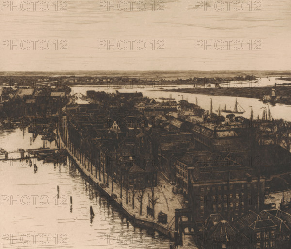Harbour, Dordrecht (original title), Dordrecht I (original title), View of Dordrecht looking north from the tower of the Grote Kerk, print, annotation: '3rd state', printmaker: Willem Witsen (signed by artist), 1900, paper, etching, intaglio printmaking technique, height 323 mm x width 368 mm, city-view in general, 'veduta', river, A sepia-toned bird's-eye view of a riverside town showing rows of tightly packed buildings with pitched roofs lining a waterfront; narrow streets and leafless trees run between the buildings, and docks extend into the water where small boats and sailboats are moored or sailing; a winding river cuts across the scene with low-lying banks and scattered structures along its edge, and the distant horizon is marked by a thin strip of land under a pale sky streaked with fine horizontal lines.