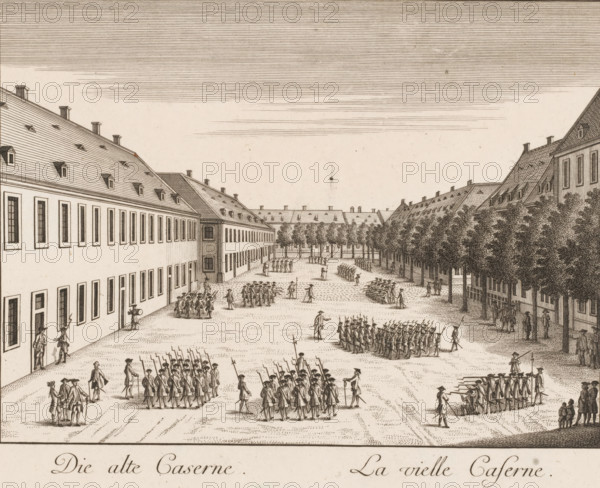 Die alte Caserne, Lavielle caserne, View of the old barracks, in Mannheim, Vues de Mannheim représentées sur vingt six planches, print, Numbered top right: 16., printmaker: Klauber, gebroeders, Augsburg, after drawing by Johann Franz von der Schlicht, publisher: Christian Friedrich Schwan, Mannheim, 1782, brothers, Bavaria, Baden-Württemberg, paper, etching, engraving, height 213 mm x width 280 mm, barracks, A detailed sepia engraving shows a broad courtyard flanked by long multi-story buildings with steeply pitched roofs and rows of dormer windows, a line of closely planted trees along one side, and numerous groups of uniformed figures arranged in formations and small gatherings across the open ground, some carrying long poles or weapons and others standing in conversation, with a few individuals walking or supervising, and patterned shading indicating cobblestones and fine crosshatching used for sky, roofs, and foliage.