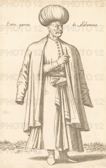 Emir, Emir parent de Mahommet, print, album page, book illustration, Print is part of an album., printmaker: Léon Davent, after drawing by Luca Penni (attributed to), after drawing by Nicolas de Nicolay (possibly), publisher: Guillaume Rouille (I), Lyon, 1555 - 1568, Léon Davet, Attributed to, paper, etching, mounted on album page, height 264 mm x width 172 mm, A monochrome line drawing of a standing man shown from head to toe wearing a large rounded turban and a long flowing robe with wide sleeves and layered drapery, his face rendered with a mustache and goatee and his gaze turned to the side, one hand tucked at his waist holding fabric while the other hand rests near his chest beneath the robe, detailed folds and shading on the garments, simple ground with short grass at the hem, and an otherwise plain background.