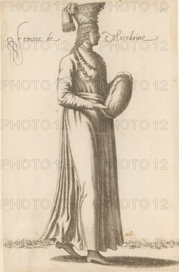 Woman from Macedonia, Femme de Macedoine, print, album page, book illustration, Print is part of an album., printmaker: Léon Davent, after drawing by Luca Penni (attributed to), after drawing by Nicolas de Nicolay (possibly), publisher: Guillaume Rouille (I), Lyon, 1555 - 1568, Attributed to, paper, etching, pasted on album page, height 260 mm x width 169 mm, A tall figure in profile faces right wearing a long, flowing gown with visible folds and a fitted waist, the sleeves extending to the wrists; the figure holds a rounded object in both hands at waist level and wears multiple layered necklaces and decorative chains around the neck and chest; the head is adorned with a tall, pointed headdress featuring a draped cloth and fringe, and long braided hair hangs down the side; bare feet are visible beneath the hem standing on a textured ground, and the image is rendered in fine linework on a light-toned background.
