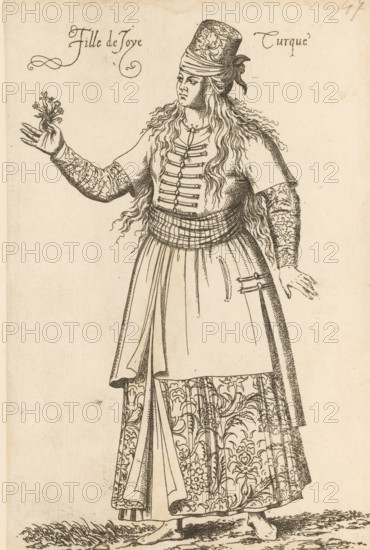 Prostitute from Turkey, Fille de Joye Turque, print, album page, book illustration, Print is part of an album., printmaker: Léon Davent, after drawing by Luca Penni (attributed to), after drawing by Nicolas de Nicolay (possibly), publisher: Guillaume Rouille (I), Lyon, 1555 - 1568, Léon Davet, Attributed to, paper, etching, mounted on album page, height 254 mm x width 169 mm, A tall figure wearing a patterned cylindrical hat and long wavy hair stands with one arm extended holding a small leafy sprig and the other arm relaxed at the side; the figure wears a short-sleeved top with decorative fastenings down the front, long ornate sleeves with floral motifs, a wide wrapped sash at the waist, and a long skirt with large floral patterns and draped panels, and the feet are bare standing on textured ground.