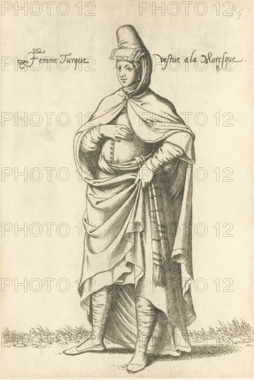 Turkish woman in North African Islamic clothing, Femme Turque vestue a la Moresque, print, album page, book illustration, Print is part of an album., printmaker: Léon Davent, after drawing by Luca Penni (attributed to), after drawing by Nicolas de Nicolay (possibly), publisher: Guillaume Rouille (I), Lyon, 1555 - 1568, Attributed to, paper, etching, pasted on album page, height 258 mm x width 176 mm, A monochrome engraving of a standing figure wearing layered draped garments and a tall rounded headpiece with a rectangular ornament at the forehead, a cloak fastened at the throat that falls over the shoulders, a gathered skirt held with one hand, a belted waist with decorative buttons, long fitted sleeves, and ankle-high footwear; the figure stands on a ground with short grass and faces slightly to one side with a calm facial expression.
