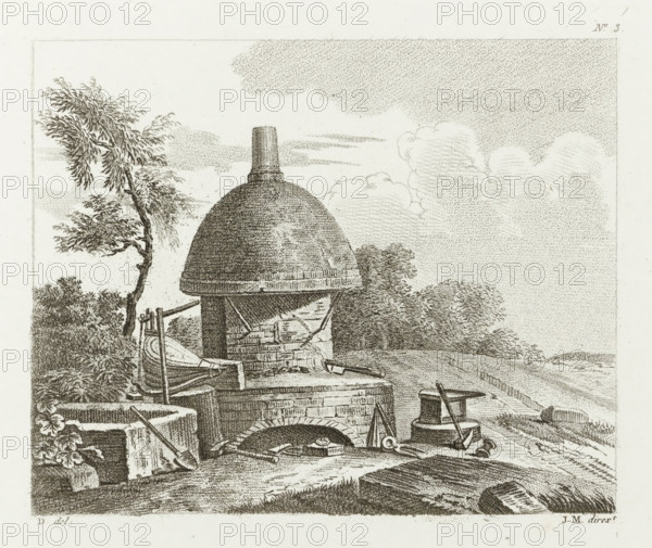 Oven with bellows, anvil and tools in the open air, Drawing examples, first writing, I.er cahier d'etudes, print, album page, Series number, 3, This print is part of an album., after drawing by Dubois, supervision: Jacques Marchand, France, publisher: Basset, Paris, c. 1800 - c. 1825, Jacques Marchand, Dubois, Basset, printmaker, after drawing by, supervision, publisher, paper, etching, engraving, stippelwerk, crayon manner, height 165 mm x width 195 mm, blast-furnace, bellows, A detailed monochrome illustration shows a domed brick kiln or furnace with a cylindrical chimney atop, set in a rural landscape. The kiln sits on a stone base with an arched opening revealing tools and a shallow hearth inside. Various metalworking tools and vessels are arranged around the kiln, including tongs, a hammer, a bucket, and a small anvil or stand. A wooden frame with straps and a bellows-like object leans against one side. Foliage surrounds the scene with a windswept tree to the left and dense shrubb...