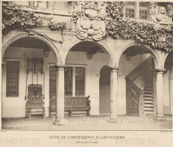 Cour de l'imprimerie plantinienne, Courtyard of the Plantijn printing house in Antwerp, Views of the Plantijn printing house, photomechanical print, View of the courtyard of the Plantijn printing house. Gallery by the stairs., maker: Joseph Maes, 1848 - 1908, Joseph Maes, paper, collotype, photogravure, height 311 mm x width 445 mm, The Plantijn printing house was the printing house and residence of the Plantin-Moretus publishing family, currently the Plantin-Moretus Museum., printing, printing office, Antwerp, A sepia-toned photograph showing an arched arcade with stone columns supporting rounded arches, a covered gallery above, and ivy growing along the upper brickwork; ornamental stone busts and decorative carvings are set into the façade above the arches; beneath the arches are wooden doors and windows with leaded panes, a carved wooden bench, and an ornate metal or stone basin with decorative supports; a stairway with a carved balustrade rises under one arch; the ground is paved w...