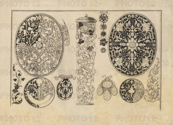 designs for snuffbox and jewelry lids, print, album page, ornamental print, Series number, 12, 16, Left and right a design for a snuffbox lid. In the center an ornamental column and at the bottom designs for jewelry. Black ornaments. Print is part of an album., number: '12', printmaker: Johann Lorenz Hönnig, Nuremberg, 1707, Bavaria, paper, engraving, height 134 mm x width 185 mm, ornaments, art, snuff-box, jewels, A beige sheet with a thin rectangular border contains a series of black ink ornamental designs including two large oval medallions filled with intricate scrolling foliage and floral motifs, each with a central rosette and contrasting dark backgrounds; a narrow vertical column topped with a domed cap and covered in leafy scrollwork and oval textured elements; a vertical row of small floral rosettes beside the column; several smaller circular and egg-shaped ornaments featuring dense arabesque patterns and stylized leaves; a cluster of three tumbled circular motifs with lattice...