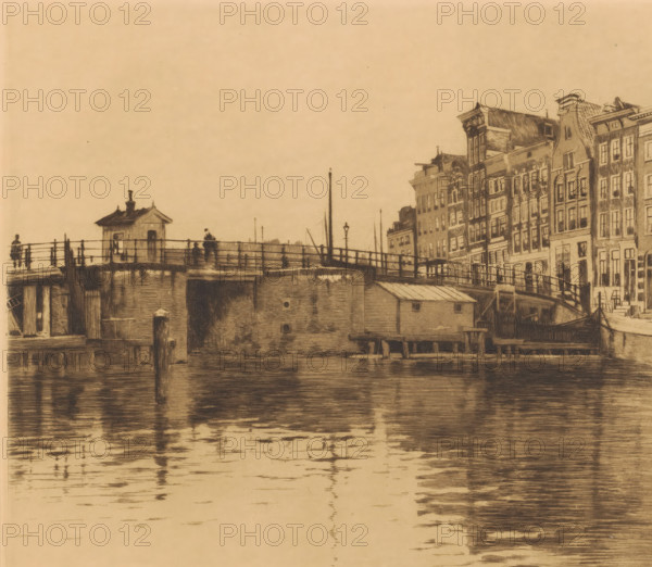 View of the Waalseilandsgracht towards the Kraansluis, Kraansluis, houses on the right (original title), print, annotation: 'second state', printmaker: Willem Witsen (signed by artist), c. 1911 - c. 1912, paper, etching, aquatint, height 279 mm x width 318 mm, urban housing, bridge in city across river, canal, Amsterdam, A sepia-toned scene showing a waterfront with a bridge and a row of narrow, multi-story buildings along the right edge, the buildings featuring tall windows and varied rooflines; the bridge has railings, a small hut-like structure, lamp posts, and a few silhouetted figures standing on it; wooden pilings and a low waterside building sit at the base of the bridge, and the water in the foreground reflects the bridge and buildings with horizontal rippling marks.
