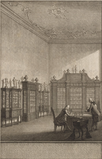 Cabinet of Bernhard Siegfried Albinus, print, In the cabinet of Bernhard Siegfried Albinus in Leiden, two men at a table study the contents of glass jars. Against the walls stand display cases with anatomical preparations., printmaker: Noach van der Meer (II), Leiden, Amsterdam, 1751 - 1822, paper, etching, engraving, etching and engraving, height 164 mm x width 108 mm, Person, Bernard Siegfried Albinus, study, 'studiolo', library, cabinet of curiosities, 'Kunst- und Wunderkammer', An interior room rendered in fine etching lines showing tall walls and an ornate ceiling with decorative scrollwork, large cabinets and bookcases lining the walls topped by small statues and urns, a central larger cabinet with columns of small compartments, two men in period clothing at a table in the foreground—one seated and leaning forward writing or examining objects, the other standing and leaning toward the table—various small bottles or instruments on the table, a chair and a small stool nearby, and l...