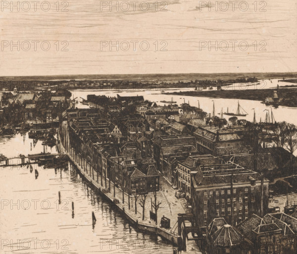 View of Dordrecht looking north from the tower of the Grote Kerk, Dordrecht I (original title), Harbour, Dordrecht (original title), print, annotation: '15a, 4, 77 in drawn triangle', annotation: '2nd state', printmaker: Willem Witsen (signed by artist), 1900, paper, etching, intaglio printmaking technique, height 323 mm x width 368 mm, city-view in general, 'veduta', river, A detailed sepia-toned etching shows a riverside town seen from above with rows of tightly packed buildings and rooftops lining a waterfront street, bare trees dotting the sidewalk, and small docks extending into calm water; boats and sailboats are moored or sailing on the river, a bridge spans the water near the foreground, and a wide expanse of sky with horizontal sketch lines stretches above the distant flat shoreline.