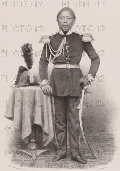 Portrait of Youda Negara, Prince of Djoejocarta, print, The sitter stands next to a table with a bicorne hat on it. He is wearing a military uniform., printmaker: Johan Hendrik Hoffmeister, printer (person): Royal Lithographic Printing House of E. Spanier, The Hague, c. 1851 - c. 1883, 1860, printer (person), paper, chine collé, lithography, lithography on chine collé, height 555 mm x width 440 mm, historical persons (full length portrait), Java, Central Java, Yogyakarta, A full-length portrait of a person standing and facing forward, wearing a dark formal military uniform with decorative braided cords across the chest, ornamental shoulder epaulettes, a high collar, patterned cuffs, and a belt with a central decorative buckle; one hand rests on the edge of a small round table draped with a cloth, the other hand holds the hilt of a curved sword hanging at the side; a tall plumed hat sits on the table beside the person; the figure wears fitted trousers and pointed shoes and stands on a p...